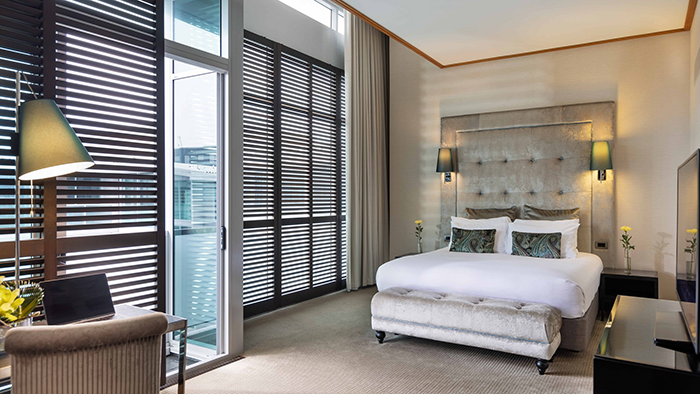 A guest room at the Sofitel Auckland Viaduct Harbour Hotel. This room has access to a balcony where guests can enjoy the waterfront view.