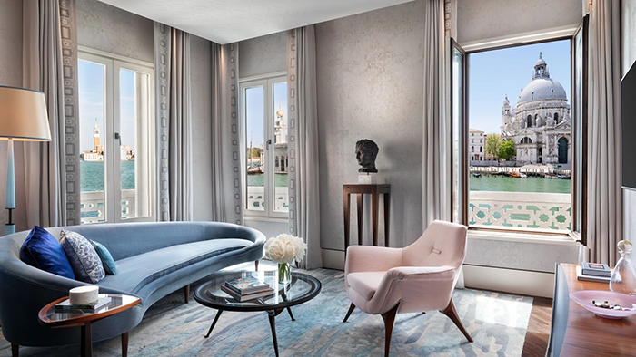 One of the guest suites at The St. Regis Venice in the Floating City. The Basilica Santa Maria della Salute is clearly visible through a window.