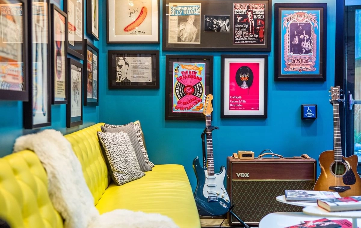 A common area inside the Verb Hotel in Boston. An electric guitar, an acoustic guitar, and a VOX amplifier sit next to the sofa.