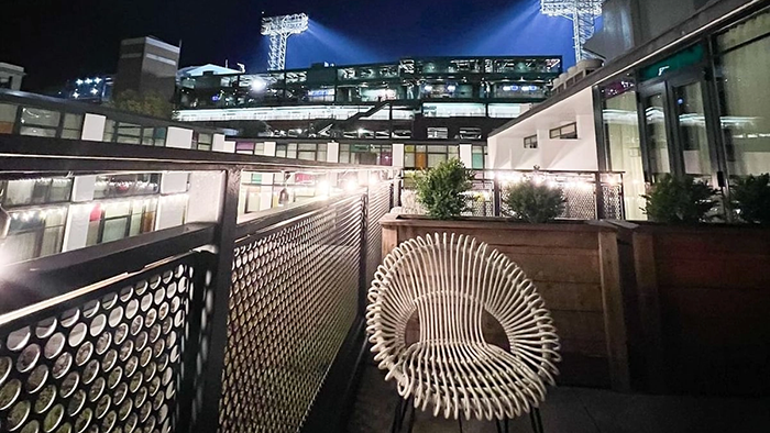 A nighttime view of Fenway Park from a guest room's balcony at The Verb Hotel.