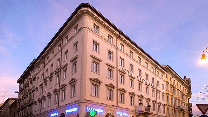 A photo of the outside of the Victoria Hotel Letterario in Trieste, Italy. The words 