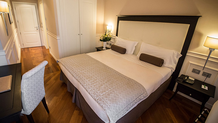 A guest room inside the Victoria Hotel Letterario in Trieste. The floors are hardwood, which is pretty unusual for a hotel.