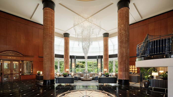 The lobby of The Westin Tokyo. There's a large, dangling chandelier in the center of the room.