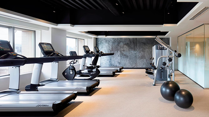 The Westin Tokyo's fitness center. Four treadmills are visible on the left side of the room.